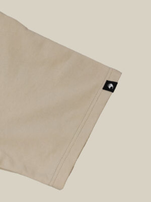 beige t-shirt logo badge